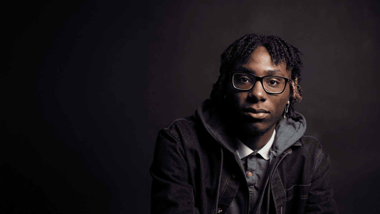 Acting headshot of a young Black man on a clean studio background