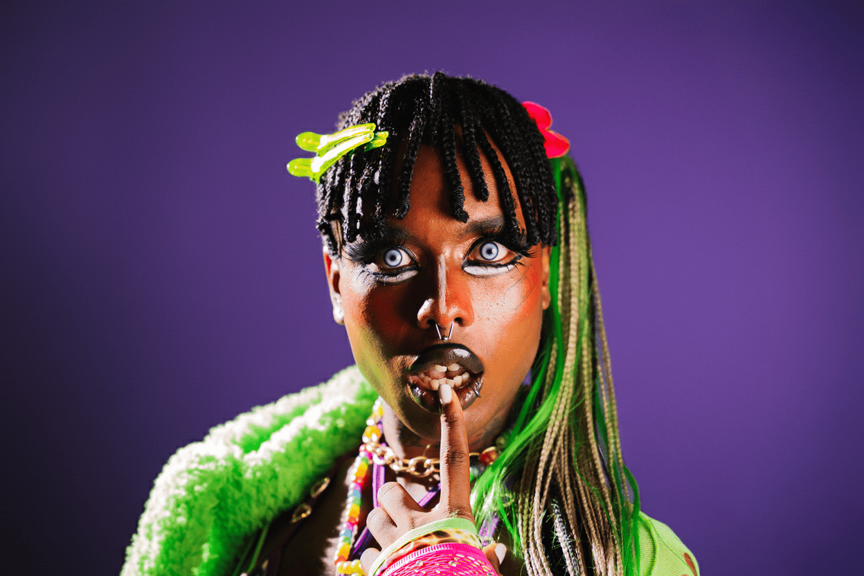 Edgy studio portrait of an alternative Black model on a purple background