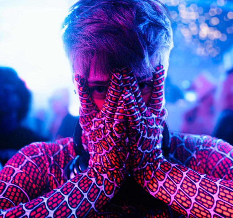 Reveller dressed as Spider-Man at a queer party