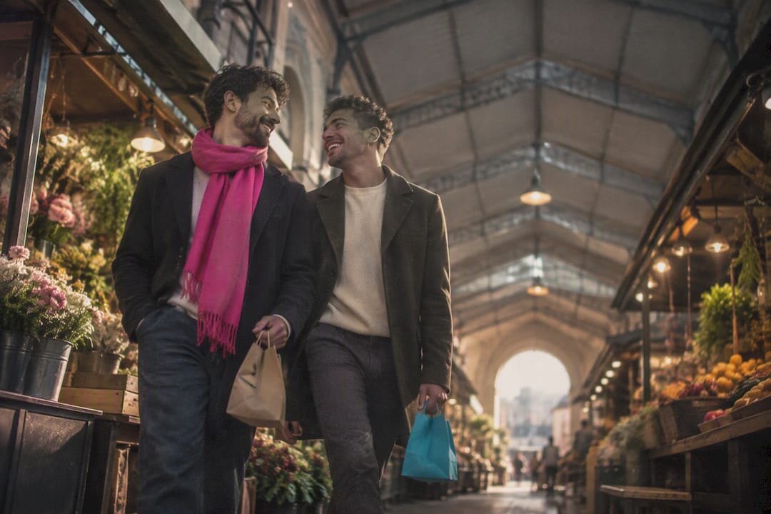 Two men laughing during city engagement photos