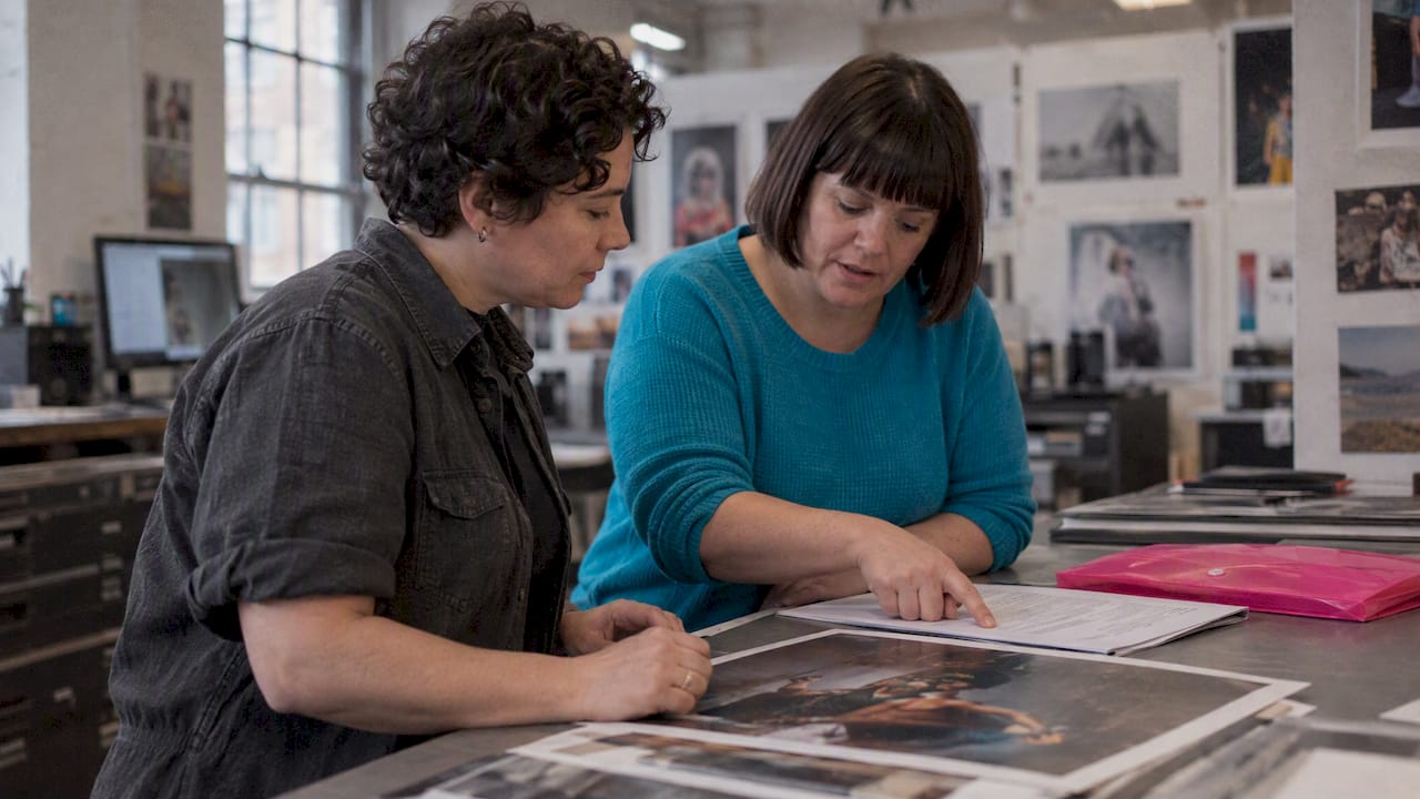 Two women reviewing an image licence before publishing
