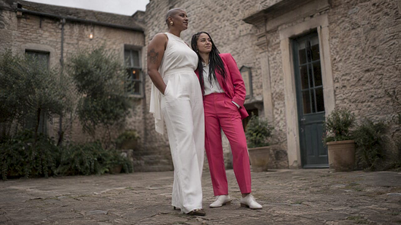 Two women showing their wedding outfits