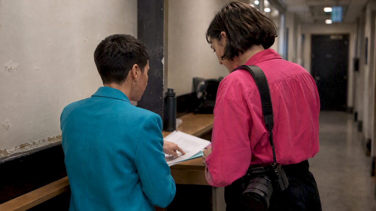 Two women reviewing an event photography brief