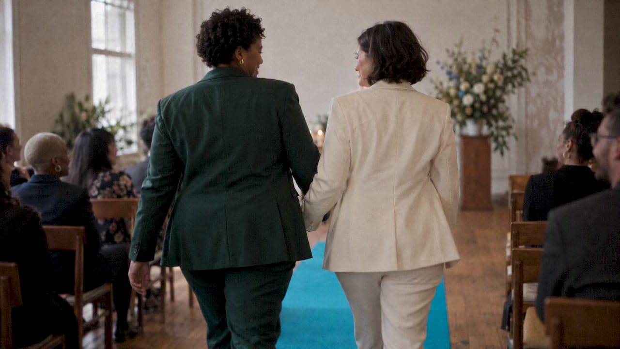 Two women enter their ceremony together